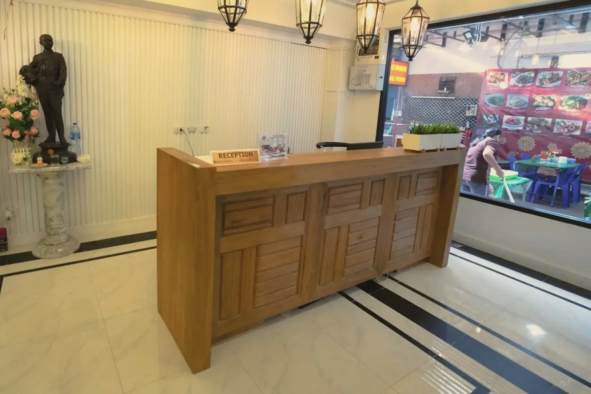 Teak reception desk under lantern pendant lights